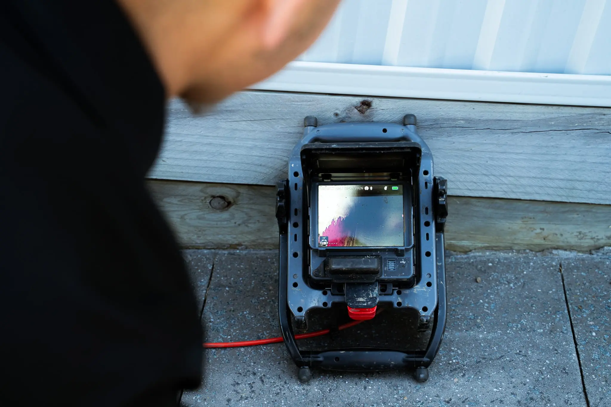 CCTV drain camera monitor showing the inside of a drain pipe