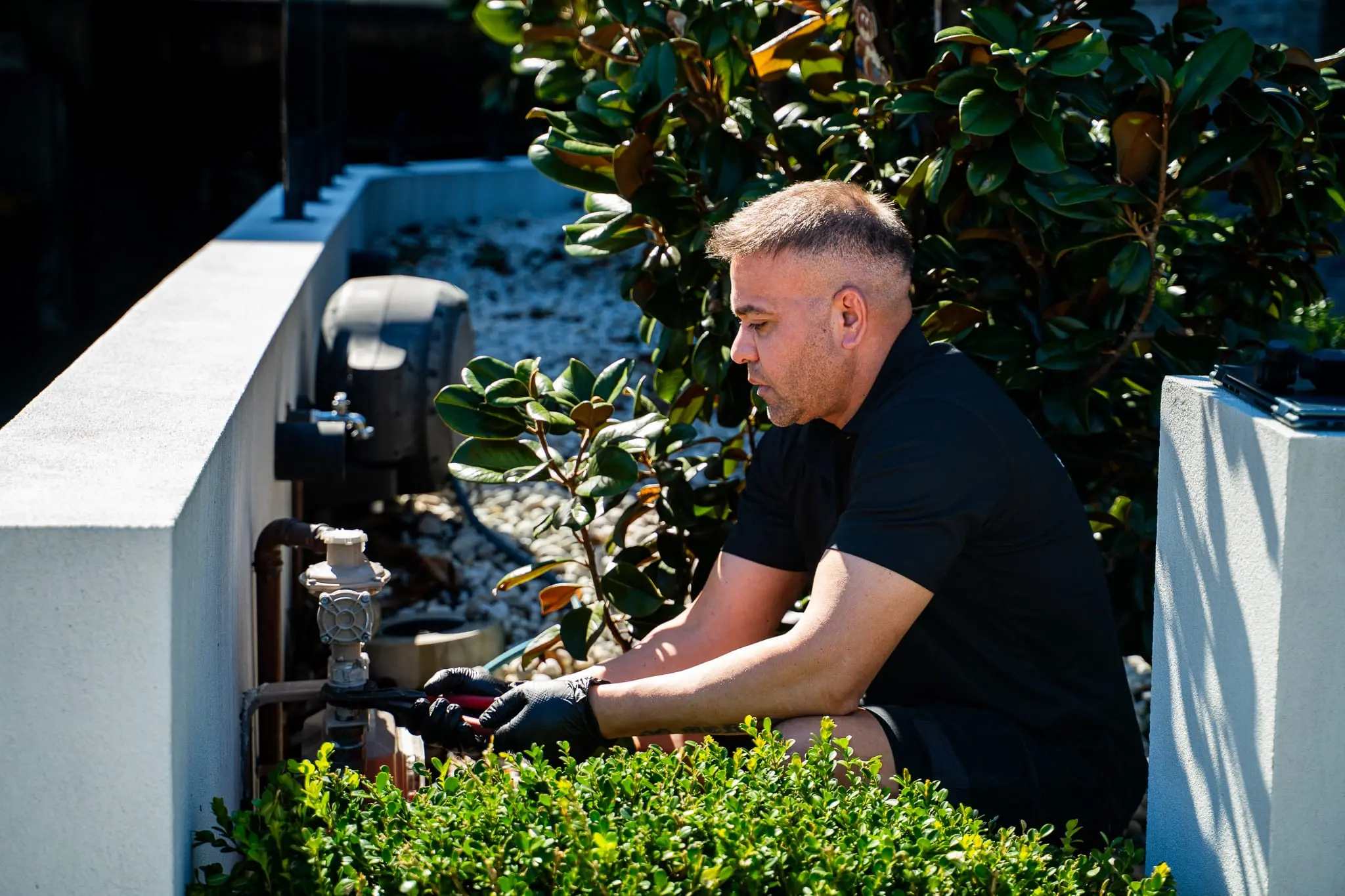 Mr Flow gas fitter working on a gas meter and regulator outside a Sydney home
