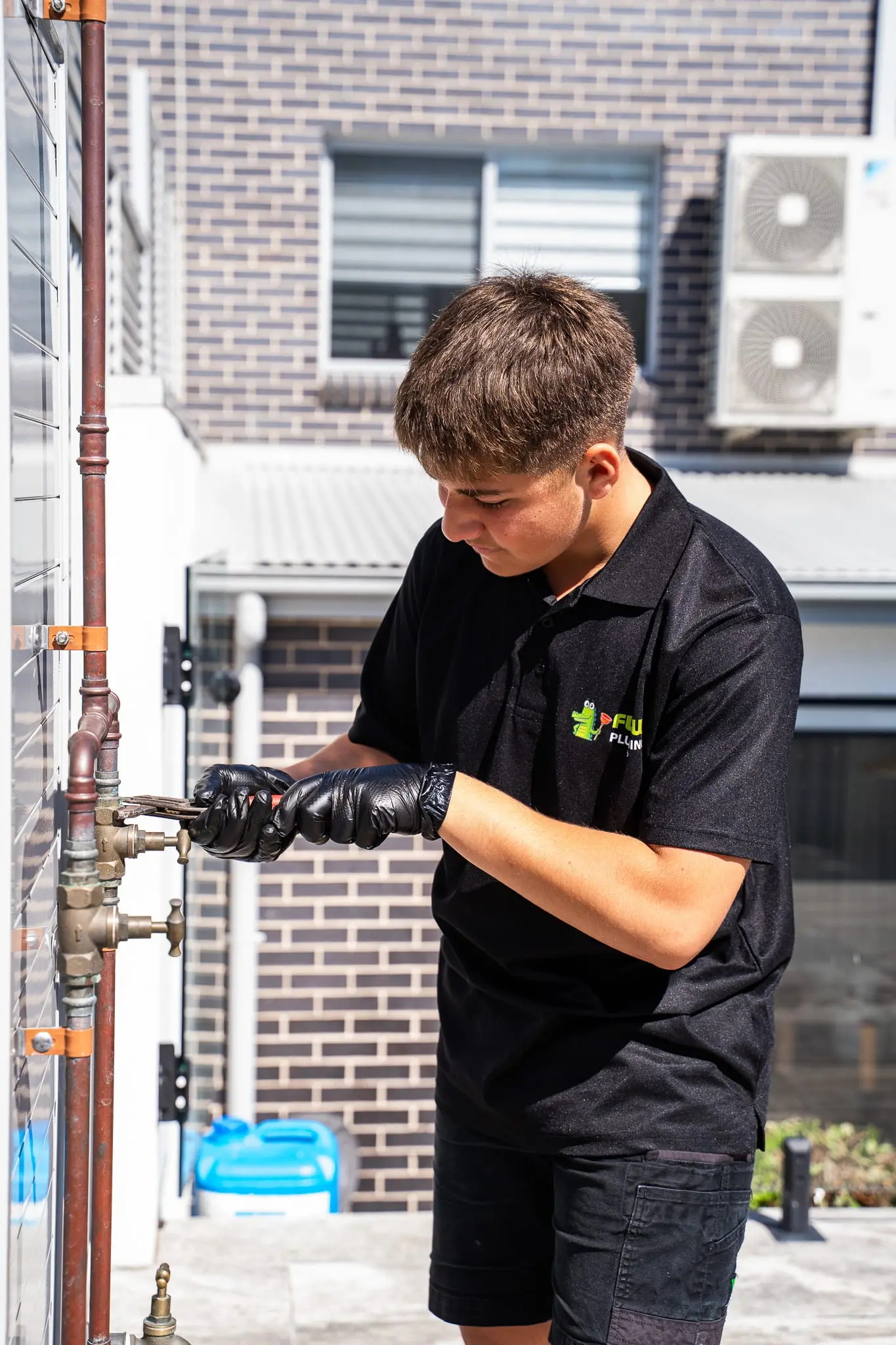 Mr Flow plumber working on copper pipework and an isolation valve