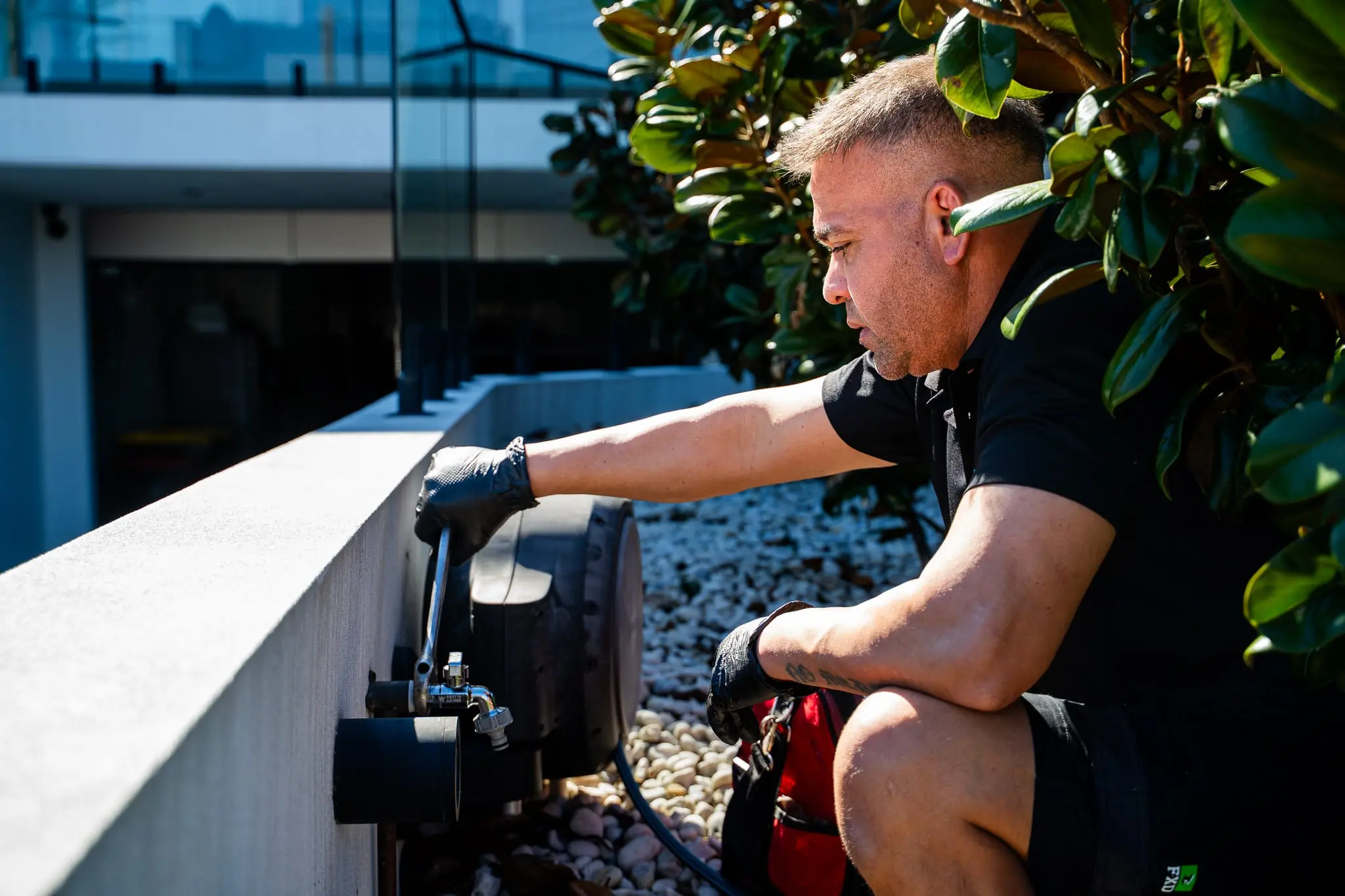 Mr Flow plumber repairing an outdoor garden tap and hose connection