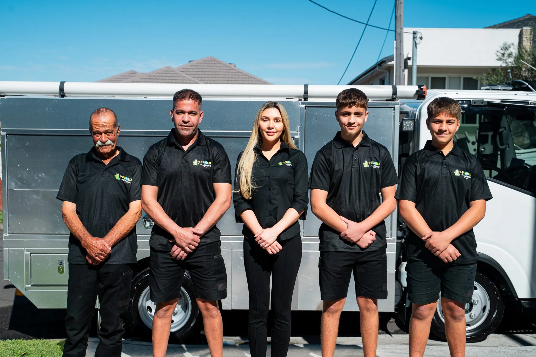 Mr Flow Plumbing team portrait beside the service truck