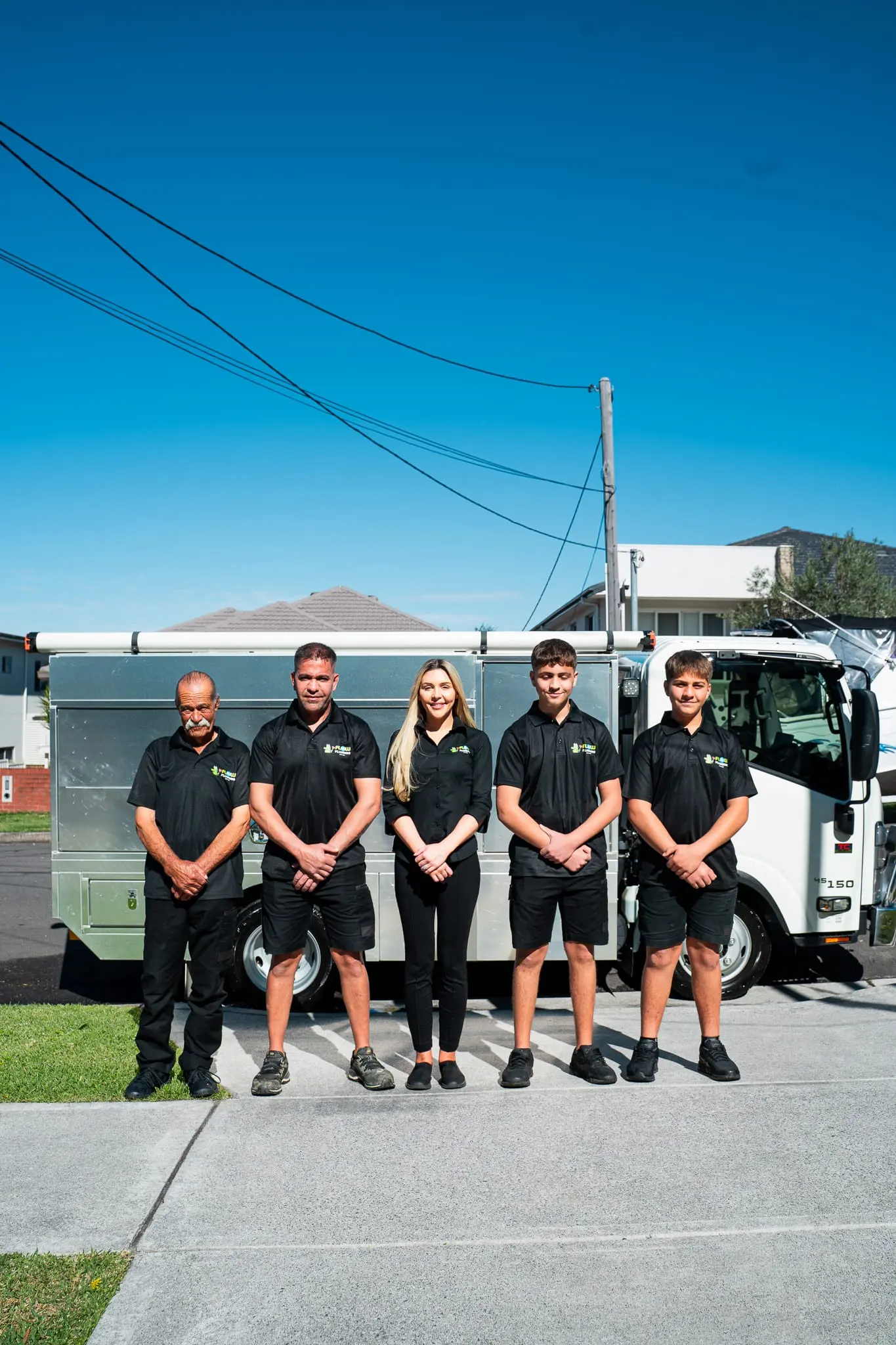 Mr Flow Plumbing team standing in front of the service truck